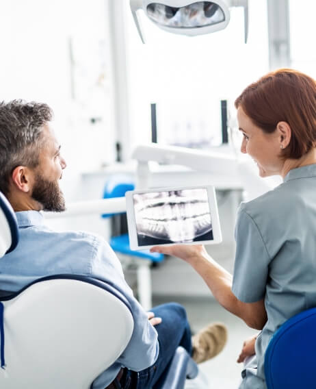 Dentist showing a patient an x ray of their teeth