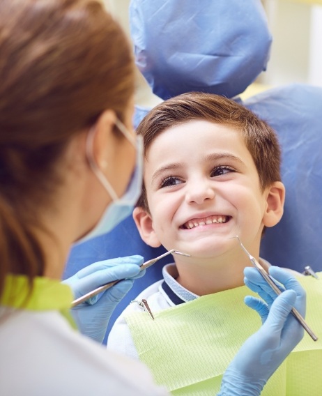 Young boy smiling at his dentist during a dental checkup