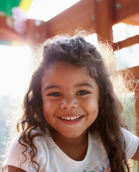 Smiling girl with curly brown hair