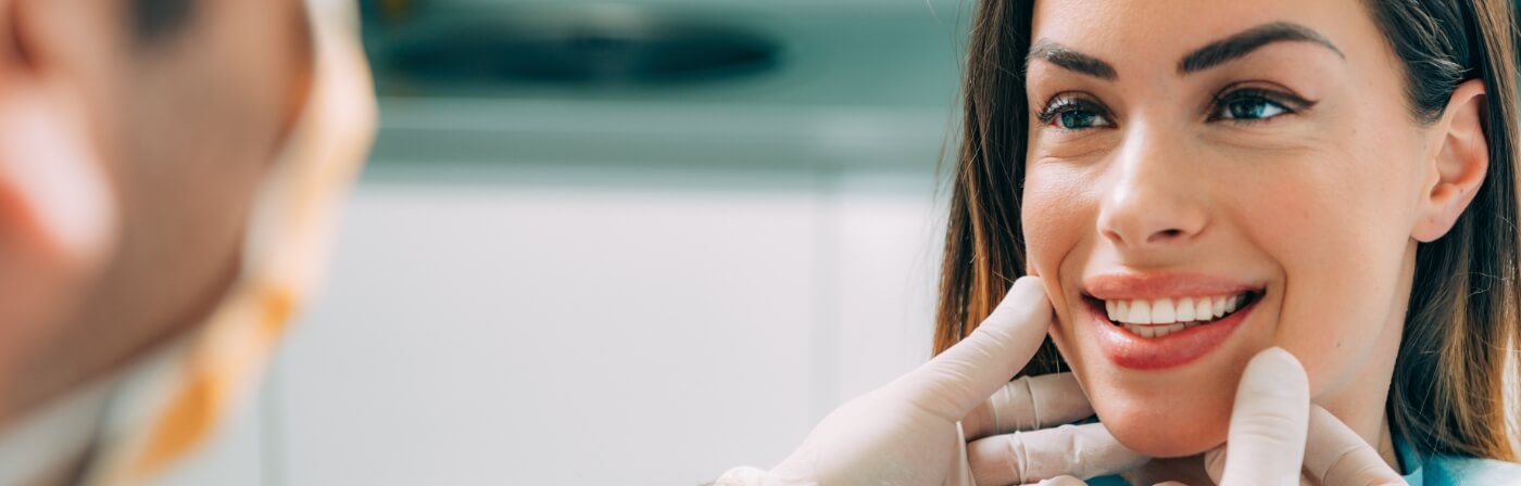 Woman smiling at her cosmetic dentist in Dallas