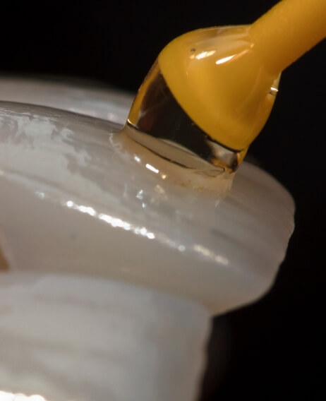 Close up of adhesive being applied to a veneer