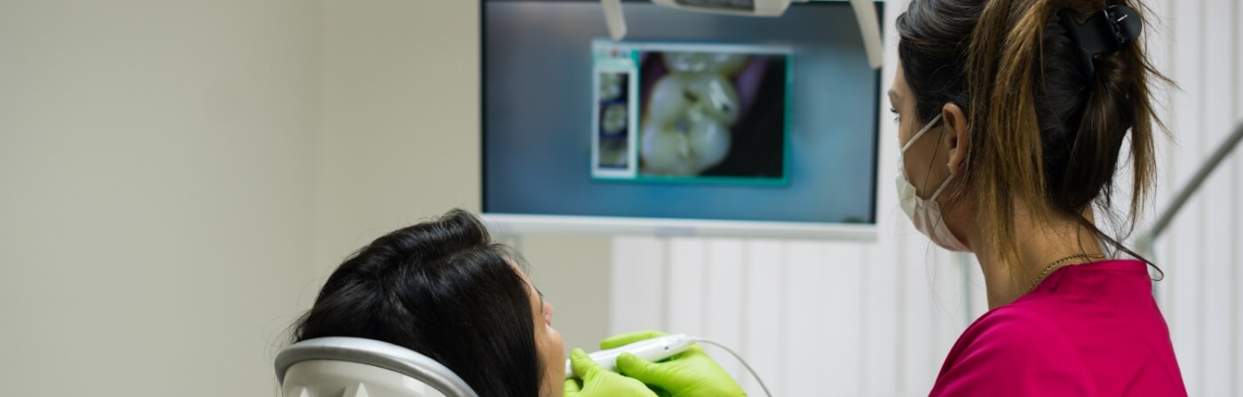 Dentist taking digital scans of a patients mouth using advanced dental technology in Dallas