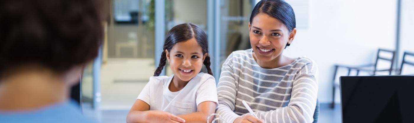 Mother and daughter checking in at dental office front desk