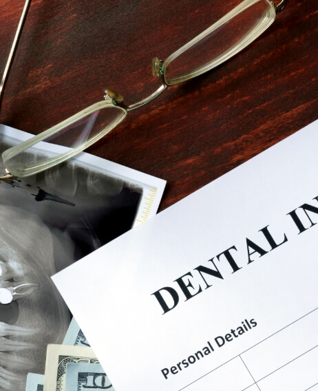 Dental insurance paperwork on wooden desk