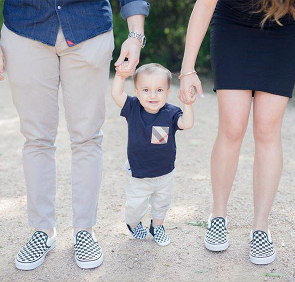 Doctor Zach Kingsberg and his wife holding hands with their baby all in checkered shoes