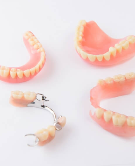 Two full dentures and two partials against white background