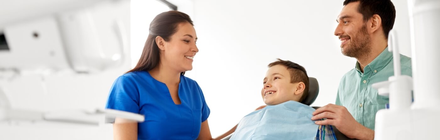 Young boy smiling at his dentist during a preventive dentistry checkup in Dallas