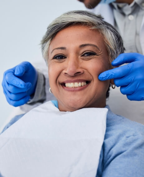 Woman in dental chair grinning