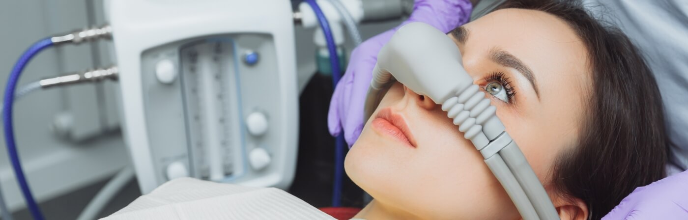 Dental patient wearing a nose mask for nitrous oxide sedation dentistry in Dallas